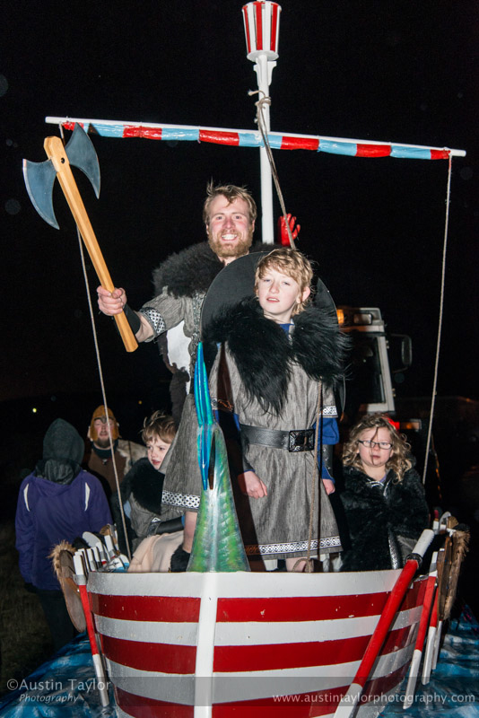 Guizer Jarl Lyle Tulloch with Brandon Lowe and the other Juniors in the Galley Nordis - the Procession Bressay Up Helly-Aa 28 February 2014